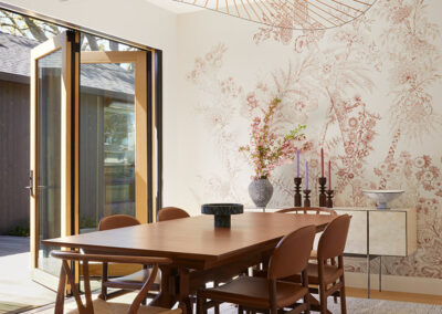 dining room with dramatic and modern art lighting and retractable accordion door leading to the patio