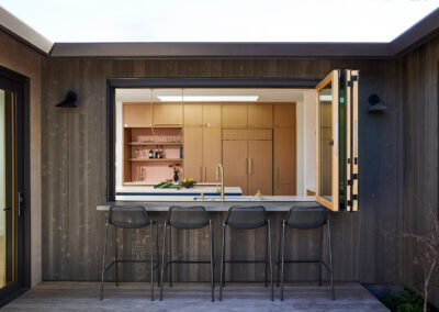 exterior patio featuring bar seating and retractable accordion window into the kitchen