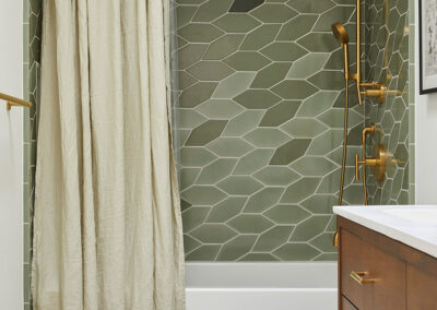 bathroom flooring and shower tile featuring a modern botanical leaf shape in shades of green