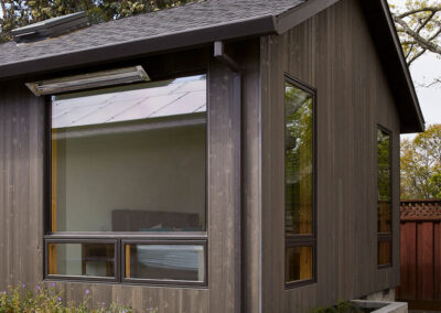 residential home exterior featuring beautiful and natural wood siding in a dark gray brown