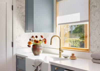 laundry room mud room with natural light and whimsical wallpaper